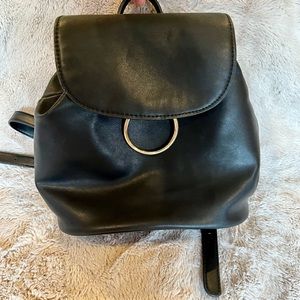 Mini black backpack with gold accents